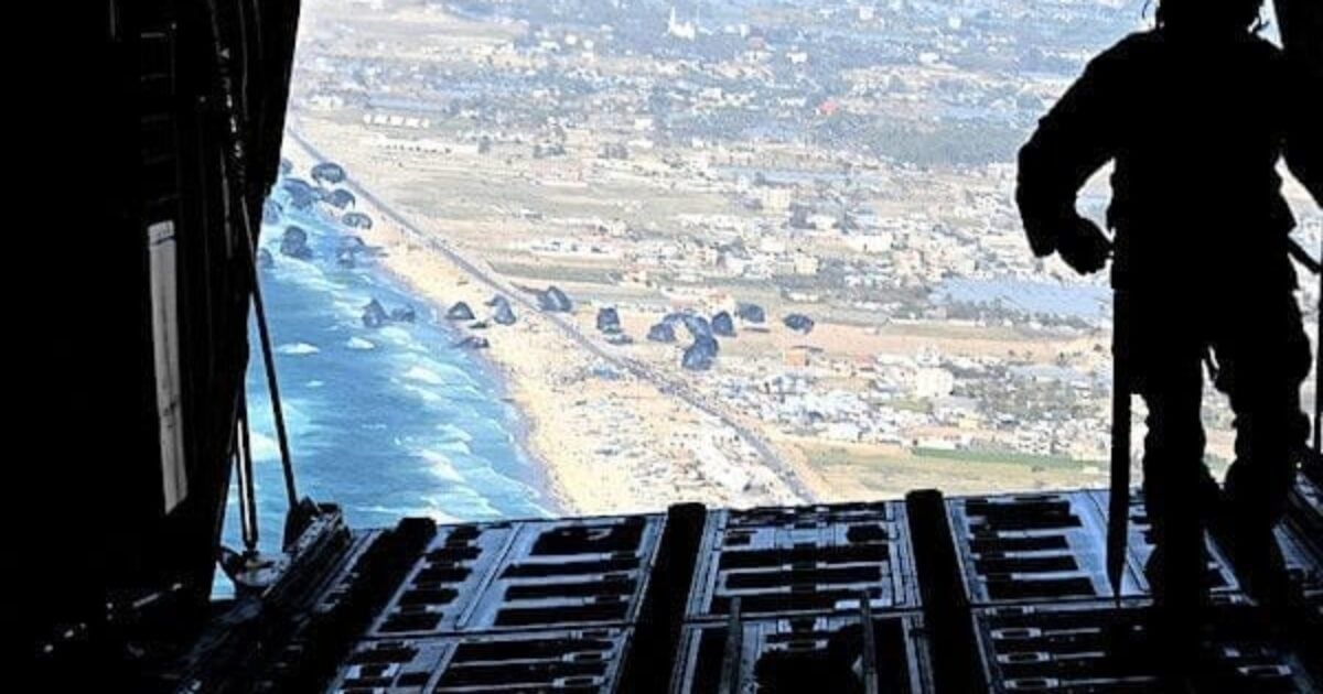 A U.S. Air Force loadmaster releases humanitarian aid pallets of food and water over Gaza on Saturday, March 2, 2024. (U.S. Air Force photo)