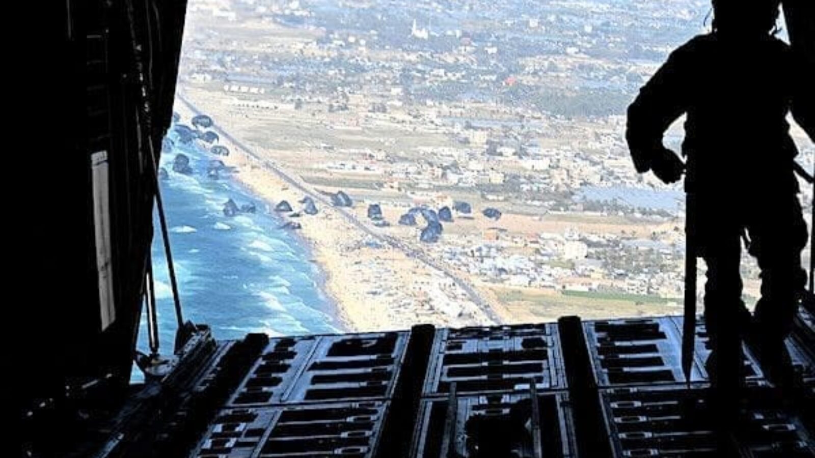 A U.S. Air Force loadmaster releases humanitarian aid pallets of food and water over Gaza on Saturday, March 2, 2024. (U.S. Air Force photo)