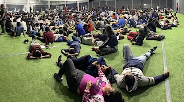 A picture leaked from inside the massive government tent facility near Eagle Pass, Texas, shows several hundred people waiting to be processed in an area intended for recreation. (Courtesy image)